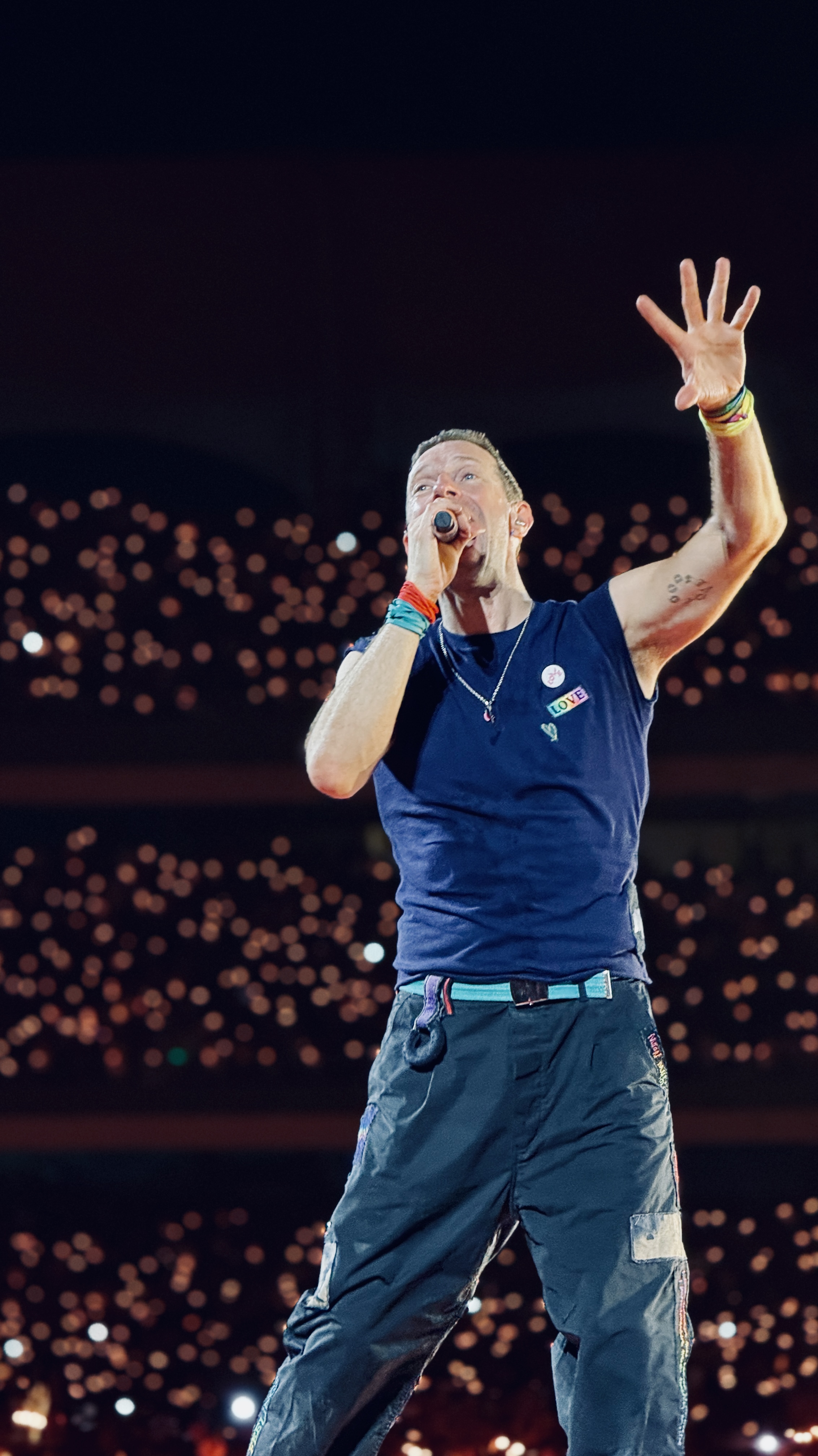 A singer performing on stage at the Coldplay concert